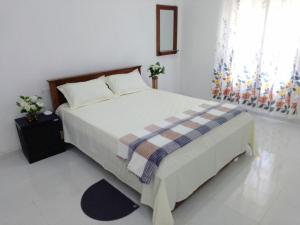 Postel nebo postele na pokoji v ubytování Tropical Suites - Airport Transit Residence