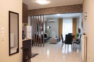 a living room with a kitchen and a dining room at Sparta View Apartments Armonias Boutique B2 in Sparti