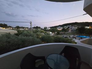 a balcony with a table and chairs and a view of a city at Lula Apartments 2 in Ulcinj