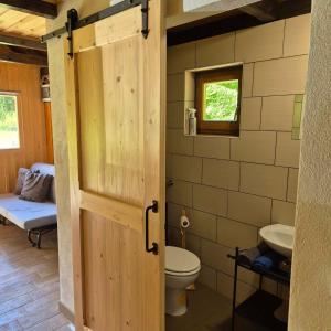 a bathroom with a toilet and a sink at Glamping Fikfak in Bled