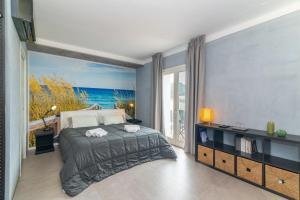 a bedroom with a bed and a large window at Dimora l'Approdo in Santa Teresa Gallura