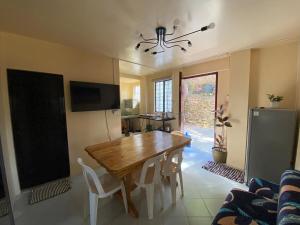 a dining room with a wooden table and chairs at Newlives Transient 2 Hillside - 1st Floor in Baguio