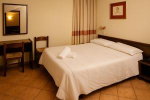 Letto o letti in una camera di Albergo Reale