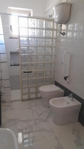 a bathroom with a toilet and a sink at Finestra su Velia in Marina di Ascea