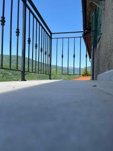 a fence with palm trees in the distance at Dai nonni di Preteto in Veccialone