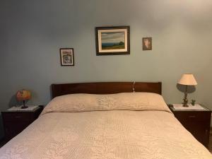 a bedroom with a bed with two nightstands and two lamps at Dai nonni di Preteto in Veccialone
