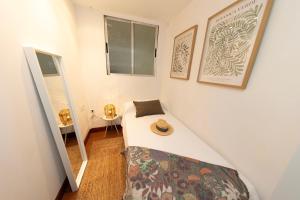 a small room with a bed with a hat on it at Apartamento El Cachupín in Laredo