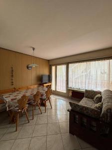 a living room with a table and a couch at Appartamenti Donatella in Cavalese