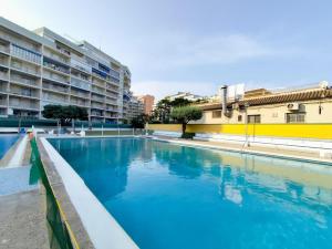 a swimming pool with blue water in front of a building at Milion Destiny Oromar Seis in Oropesa del Mar