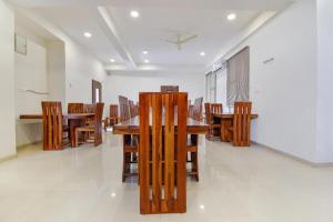 a dining room with wooden tables and chairs at Hotel Shiv Kalpana in Jaipur