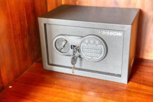 a safe with a key in it sitting on a table at WK Penida Cottage in Nusa Penida