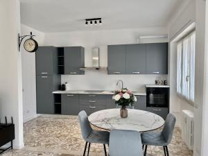 a kitchen with a table with a vase of flowers on it at Dimora Francesco in Domodossola