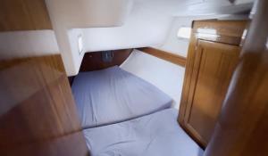 a small room with a bed and a door at Sailboat on the sea in Medulin