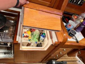 a small refrigerator filled with food in a kitchen at Sailboat on the sea in Medulin +9 photos