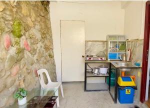 a toy kitchen with a glass table and a counter at Newlives Transient 2 Hillside - 2nd Floor in Baguio