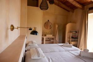 a bedroom with two beds with towels on them at Casa Albaredo, Aldea Rural, Boutique Hotel, Retreat, in O Cebrero