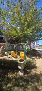 einen Spielplatz mit gelben Stühlen in einem Park in der Unterkunft New 3Room Maisonette Apartment in Sunny Day 3 Sunny Beach in Sonnenstrand