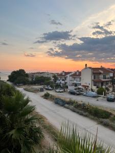 a view of a street with houses and a sunset at Orama Seaside Residence in Nikiti