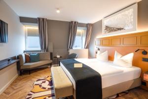 Postel nebo postele na pokoji v ubytování SEETELHOTEL Ostseehotel das Entdeckerhotel an der Ostsee und der perfekte Startpunkt für Ihre Inselabenteuer
