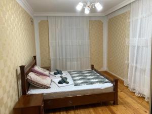 a bedroom with a bed with shoes on it at Qabala in Mekhrably +24 photos