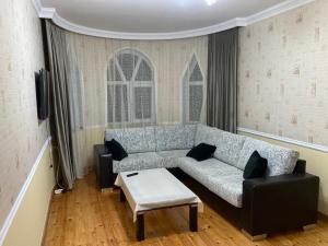 a living room with a couch and a table at Qabala in Mekhrably