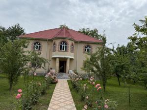 a house with a walkway in front of a garden at Qabala in Mekhrably