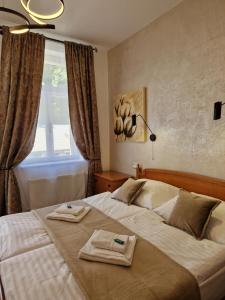Postel nebo postele na pokoji v ubytování Apartmány Aurelius