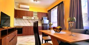 a kitchen with a table and a dining room at Elixir2 Apartment Еликсир2 in Shumen