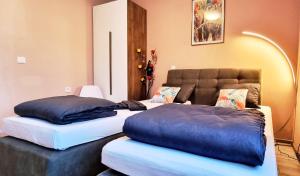 two twin beds in a room with a couch at Elixir2 Apartment Еликсир2 in Shumen