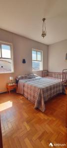 a bedroom with a bed and a wooden floor at Casa 420 in Diamantina