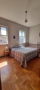 a bedroom with a bed and a wooden floor at Casa 420 in Diamantina +17 photos