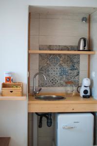 a kitchen with a sink and a counter top at Corte Santa Maria B&B in Vasto +9 photos
