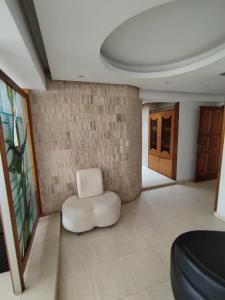 una silla blanca sentada en medio de una habitación en Cozy 2BR Apartment Near Sambil Valencia, en Naguanagua