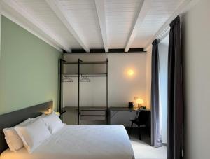 a bedroom with a white bed and a desk at Urban Living in Como