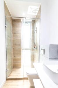 a bathroom with a shower and a toilet and a sink at Rosiem Boutique in Techirghiol +37 photos