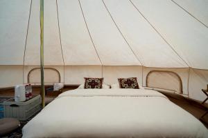 Postel nebo postele na pokoji v ubytování Nalati Jianxian B&B