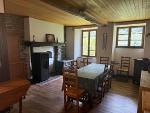 a dining room with a table and chairs and a fireplace at Chez Pascale in Melles