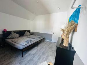 a room with a couch and a bed in it at Leitmike&Sun 4 in Greußenheim