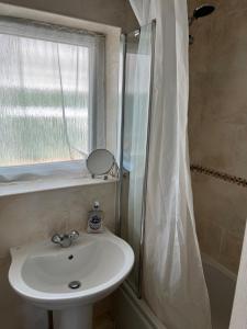 a bathroom with a sink and a shower at 2 bedroom Lake district cottage in Cockermouth +20 photos