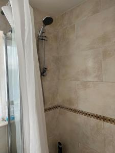 a bathroom with a shower with a shower curtain at 2 bedroom Lake district cottage in Cockermouth