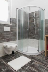 a bathroom with a shower and a toilet at M.G Apartments in Brodarica +50 photos