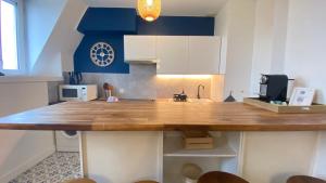 a kitchen with a large wooden counter top at Appart en Hypercentre - Le Clemenceau in Bordeaux