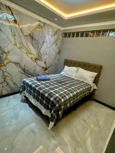 a bedroom with a bed with a plaid blanket at Condomínio Lidiane in Belém +22 photos