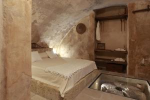 a bedroom with a bed and a tub in it at Casa Nachiro - 16th Century Oil Mill Historic Dimora in Nardò