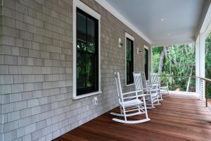 a porch with rocking chairs on a house at 2680 Gnarled Pine in Seabrook Island