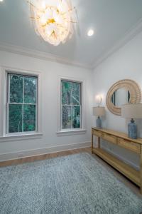 a living room with a chandelier and a mirror at 2680 Gnarled Pine in Seabrook Island