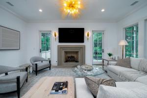 a living room with a fireplace and a tv at 2680 Gnarled Pine in Seabrook Island +45 photos