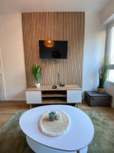 sala de estar con mesa blanca y TV en Les Quais centre-ville, en Rennes