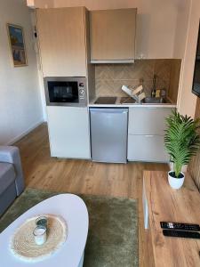 a kitchen with white appliances and a table in a room at Les Quais centre-ville in Rennes