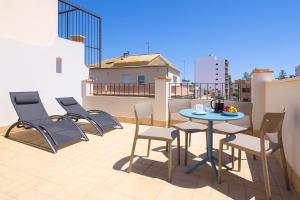 un patio avec des chaises et une table sur un balcon dans l'établissement Apartamentos Turísticos Decumano Romano by CartagenaSpain, à Carthagène